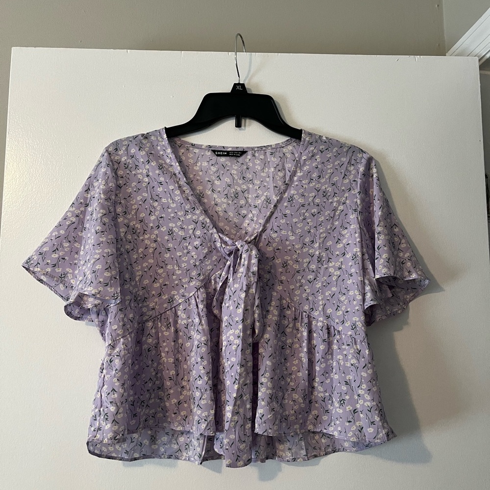 purple shirt with white flowers